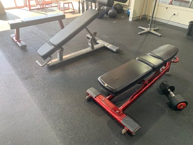 row of second hand life fitness adjustable benches in a gym fitout