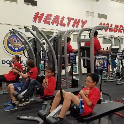 row of kids working out in a new school gym design