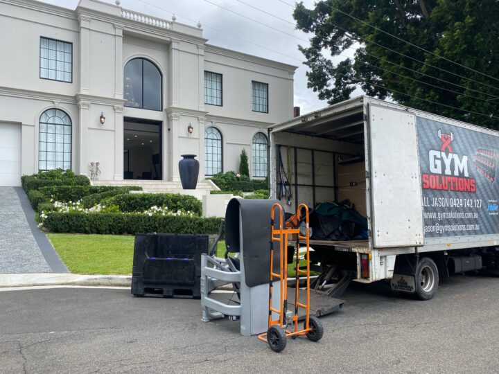 gym solution truck delivering and installing gym equipment in a home gym